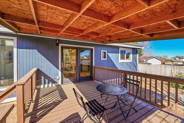 wooden terrace featuring fence