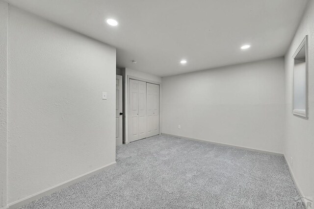 unfurnished room with carpet flooring, baseboards, and recessed lighting