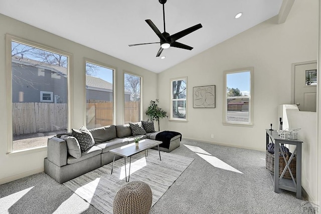 living area with carpet flooring, a ceiling fan, baseboards, and vaulted ceiling