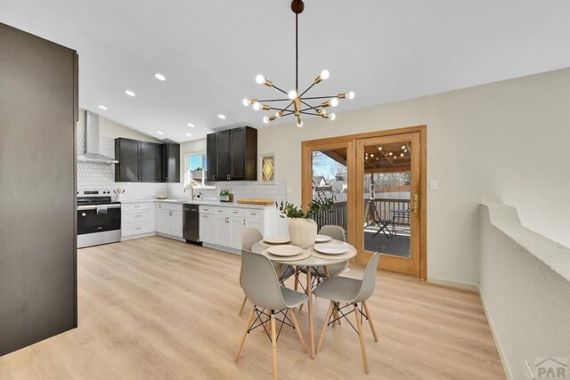 dining room featuring light wood finished floors, baseboards, recessed lighting, vaulted ceiling, and a notable chandelier