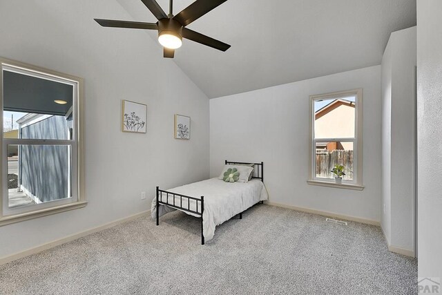 bedroom with baseboards, lofted ceiling, visible vents, and carpet