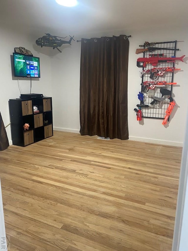 interior space featuring baseboards and wood finished floors