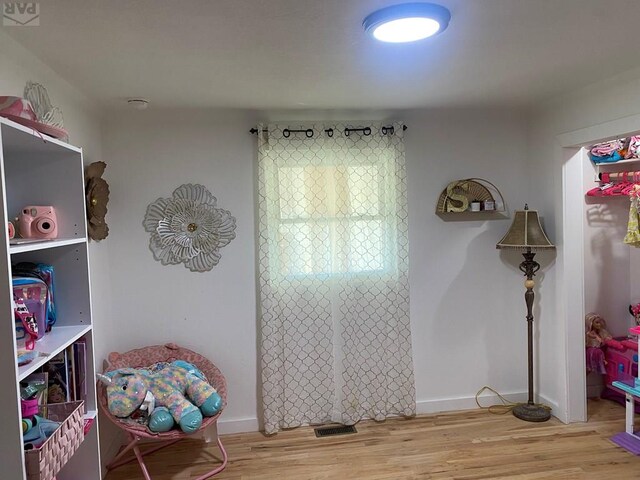 game room with wood finished floors and baseboards