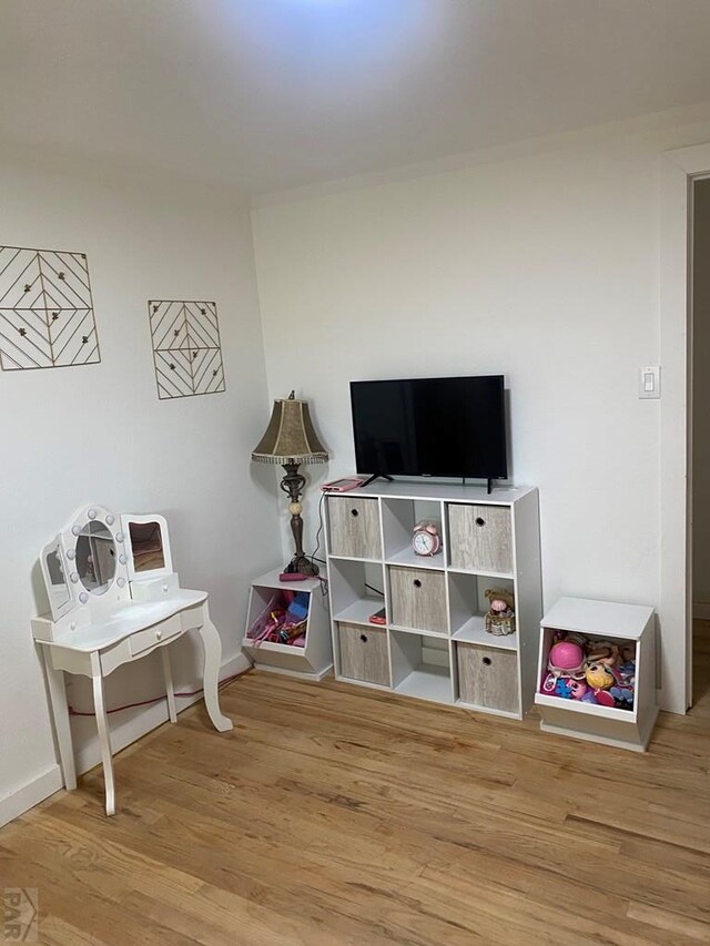 recreation room with light wood-style floors and baseboards