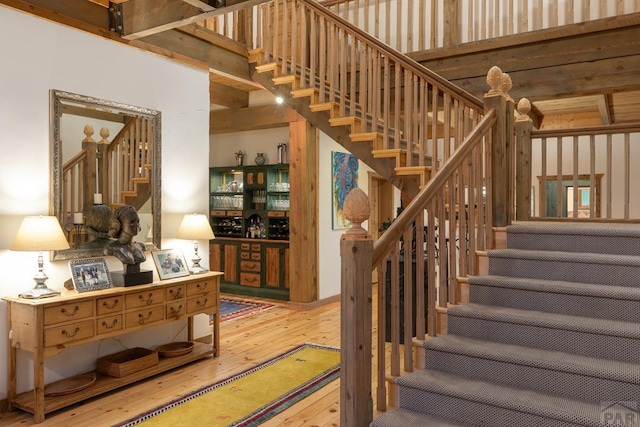 24074 Fruitland Mesa Rd, Crawford, CO 81415 - stairway featuring hardwood / wood-style flooring and a towering ceiling