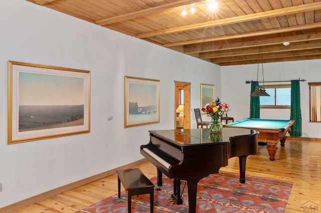 interior space with wood ceiling, beamed ceiling, and baseboards