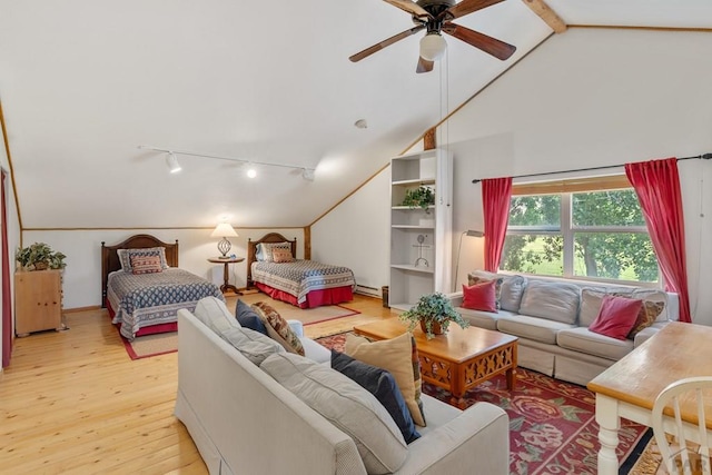 bedroom with lofted ceiling with beams, light wood-type flooring, and rail lighting