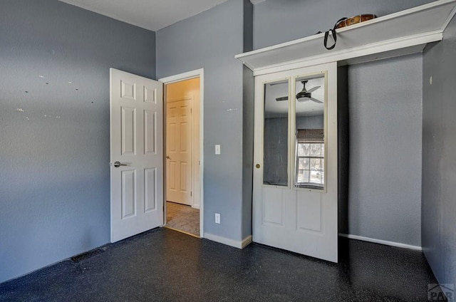 unfurnished bedroom with a closet and baseboards