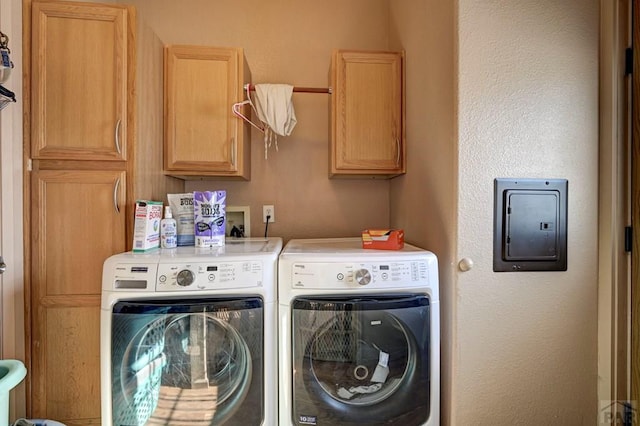 laundry room with washing machine and dryer and cabinet space