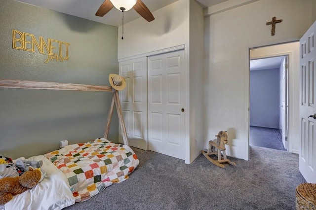 bedroom with a ceiling fan, dark carpet, and a closet