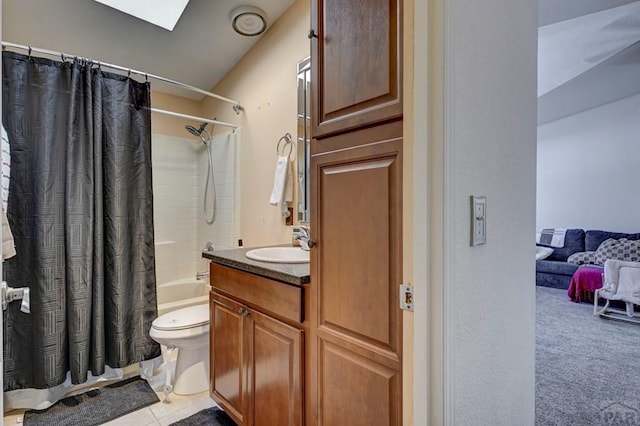 full bath featuring a skylight, shower / bath combo, toilet, tile patterned flooring, and vanity