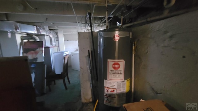 utility room with washer / clothes dryer and gas water heater