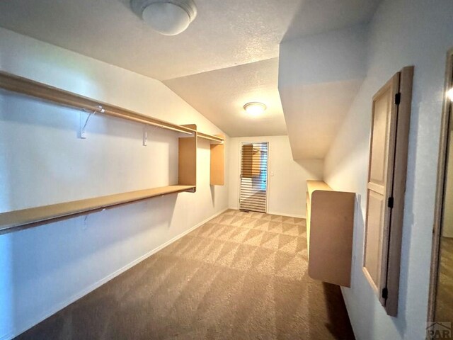 bonus room featuring baseboards, vaulted ceiling, and light colored carpet