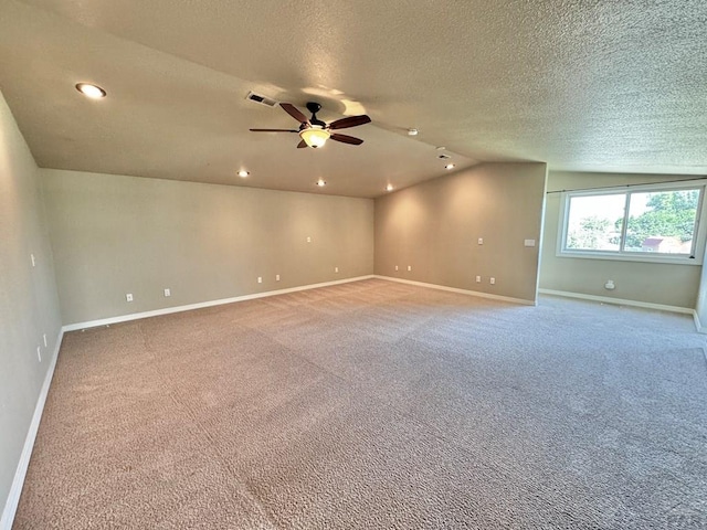 empty room featuring ceiling fan, recessed lighting, carpet flooring, baseboards, and vaulted ceiling