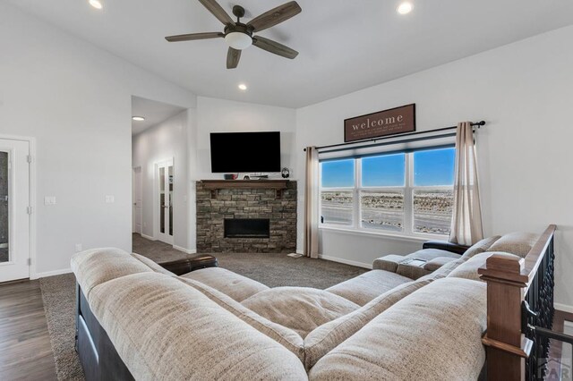 living room featuring ceiling fan, a stone fireplace, recessed lighting, and baseboards