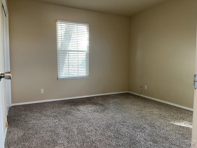 unfurnished room with baseboards