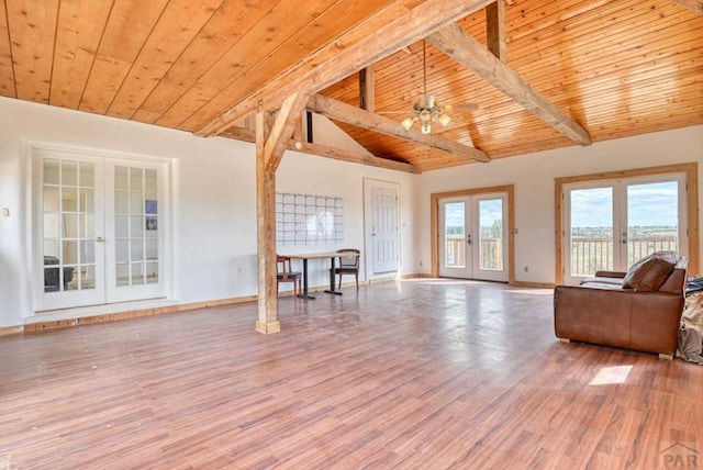 unfurnished living room with wood ceiling, ceiling fan, wood finished floors, and french doors