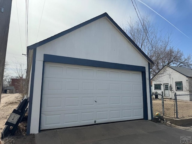 detached garage featuring fence