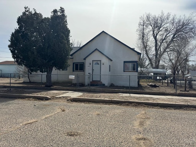 view of front of house featuring a fenced front yard and stucco siding