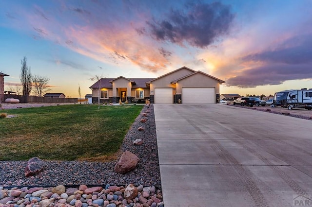 view of front of home with a front yard, a garage, fence, concrete driveway, and stucco siding