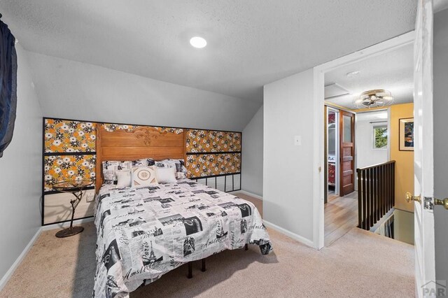 carpeted bedroom featuring vaulted ceiling and baseboards