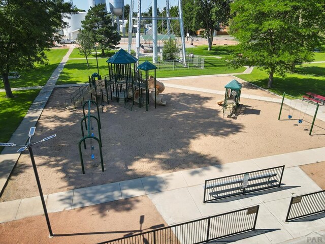 view of community featuring playground community and a lawn