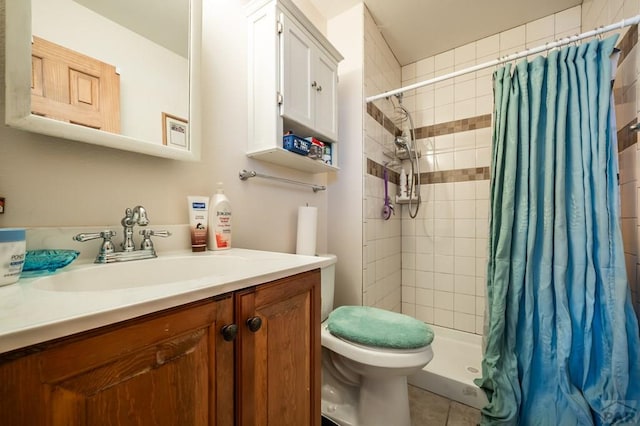 bathroom featuring tile patterned flooring, a shower stall, toilet, and vanity