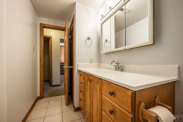 bathroom with baseboards, vanity, and tile patterned floors