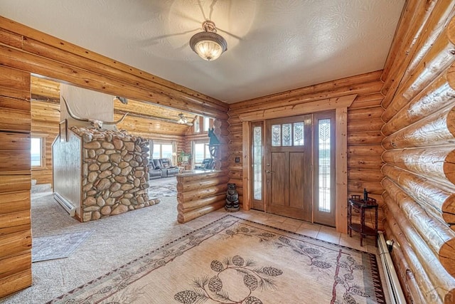 entrance foyer with a textured ceiling, a baseboard radiator, carpet, and log walls