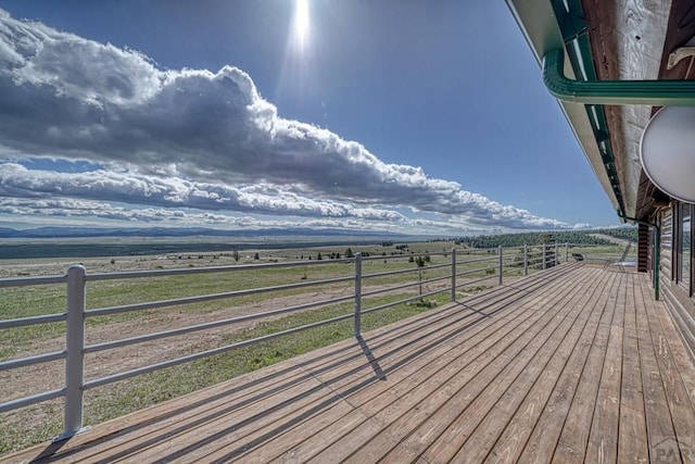 wooden terrace featuring a rural view