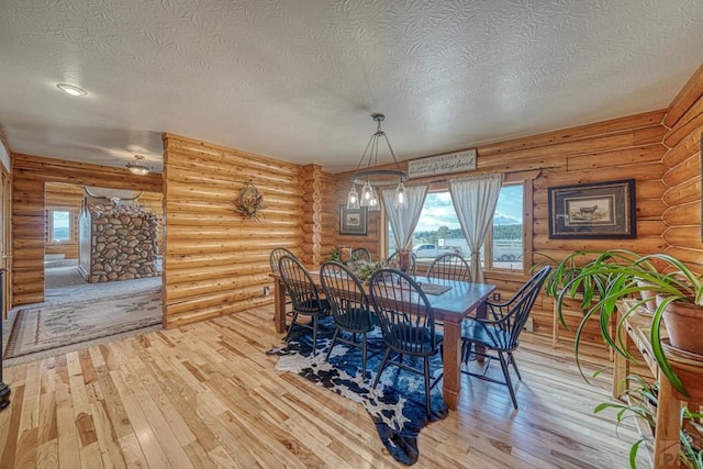 dining space featuring a textured ceiling and wood finished floors