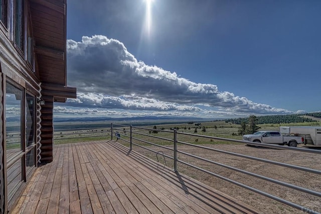 wooden deck with a rural view