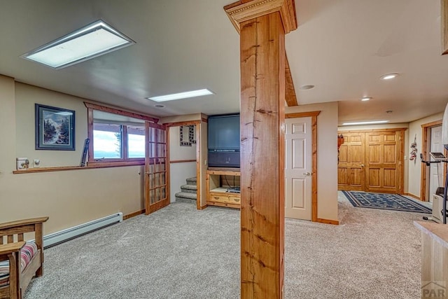 living area featuring carpet floors, baseboards, and baseboard heating