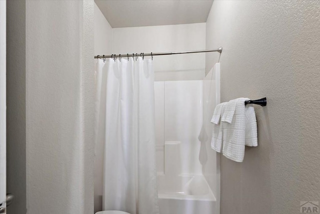 bathroom with a textured wall