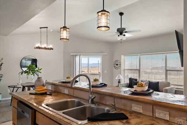 kitchen with a ceiling fan, lofted ceiling, a sink, dishwasher, and open floor plan