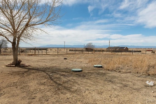 view of yard featuring a rural view and fence