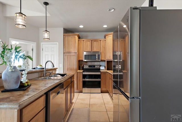 kitchen with hanging light fixtures, recessed lighting, light tile patterned flooring, stainless steel appliances, and a sink