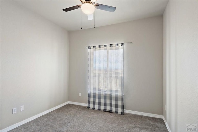 empty room featuring baseboards, ceiling fan, and carpet floors