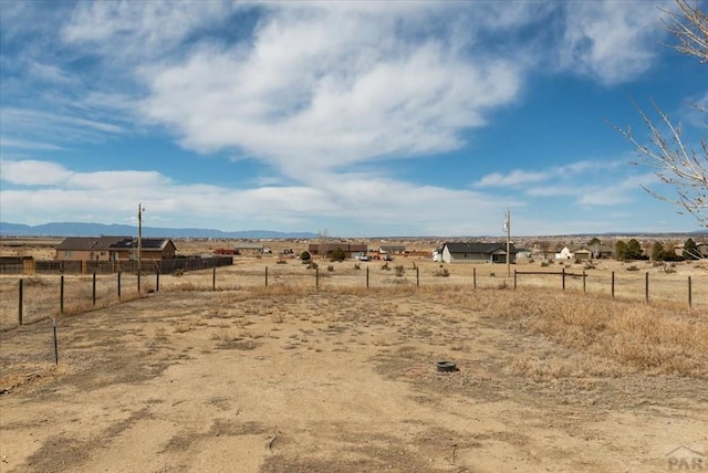 view of yard featuring a rural view and fence