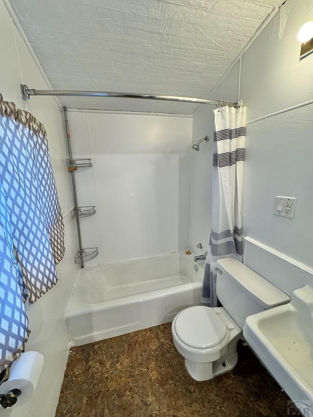 bathroom with a textured ceiling, a sink, toilet, and shower / bathtub combination with curtain