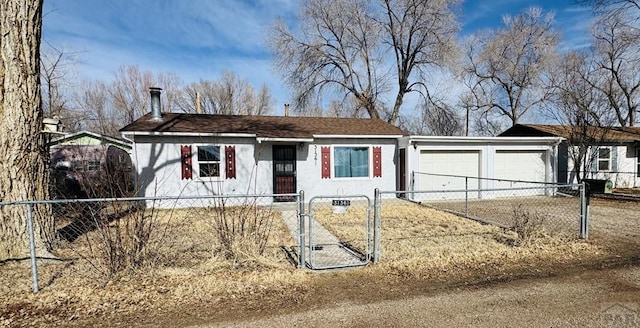 ranch-style home with a gate, driveway, roof with shingles, an attached garage, and a fenced front yard