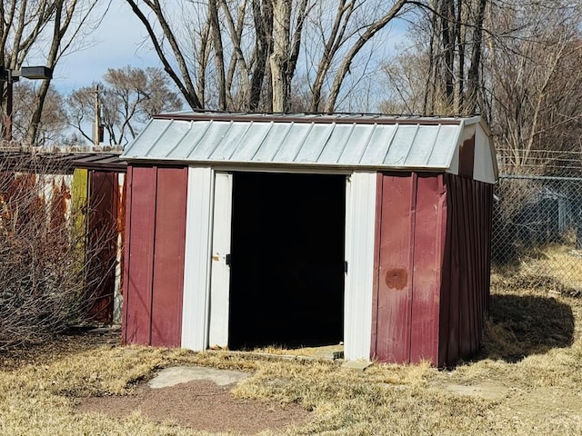 view of shed featuring fence