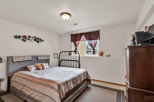 carpeted bedroom with baseboards and visible vents