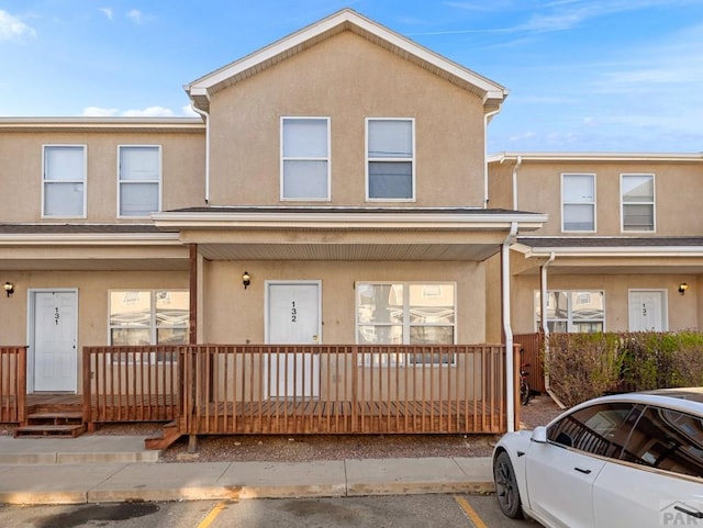 4400 Rawhide Rd Unit 132, Pueblo, CO 81008 - view of property with stucco siding, uncovered parking, and covered porch