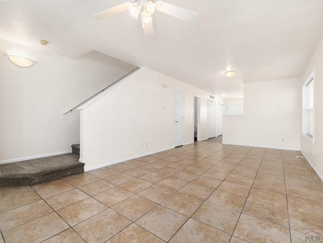 4400 Rawhide Rd Unit 132, Pueblo, CO 81008 - unfurnished living room featuring ceiling fan, baseboards, light tile patterned flooring, and stairs
