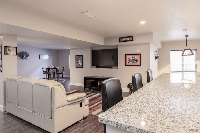 living area with recessed lighting, dark wood-style flooring, visible vents, and baseboards