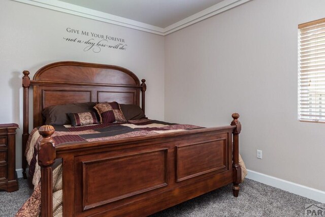 bedroom featuring ornamental molding, carpet flooring, and baseboards