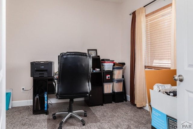 carpeted office space featuring baseboards