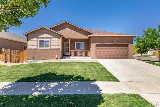 ranch-style house featuring stucco siding, an attached garage, a front yard, fence, and driveway