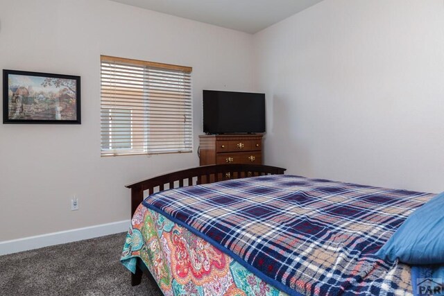 carpeted bedroom featuring baseboards